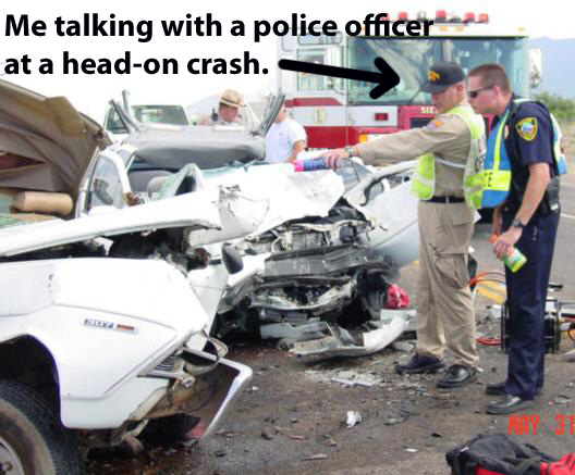 Collision investigator talking to a policeman after a car crash